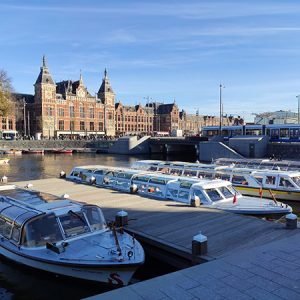 Historic Amsterdam cityscape with canal boats (Netherlands)